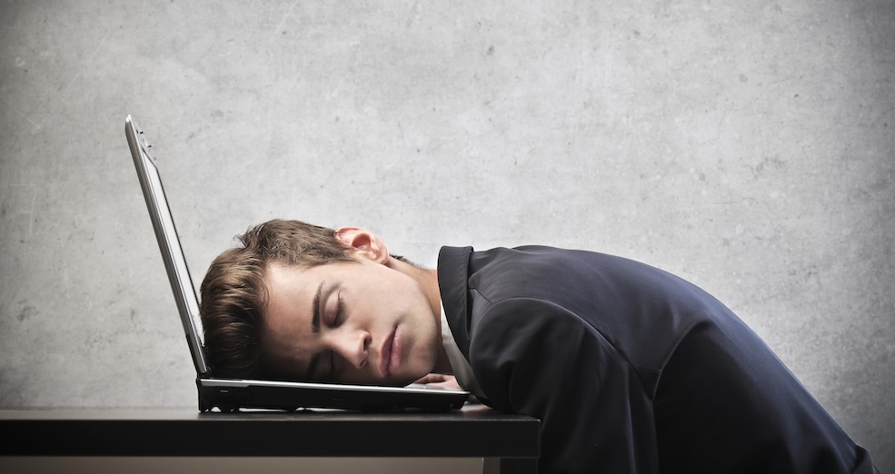 Businessman sleeping on his laptop